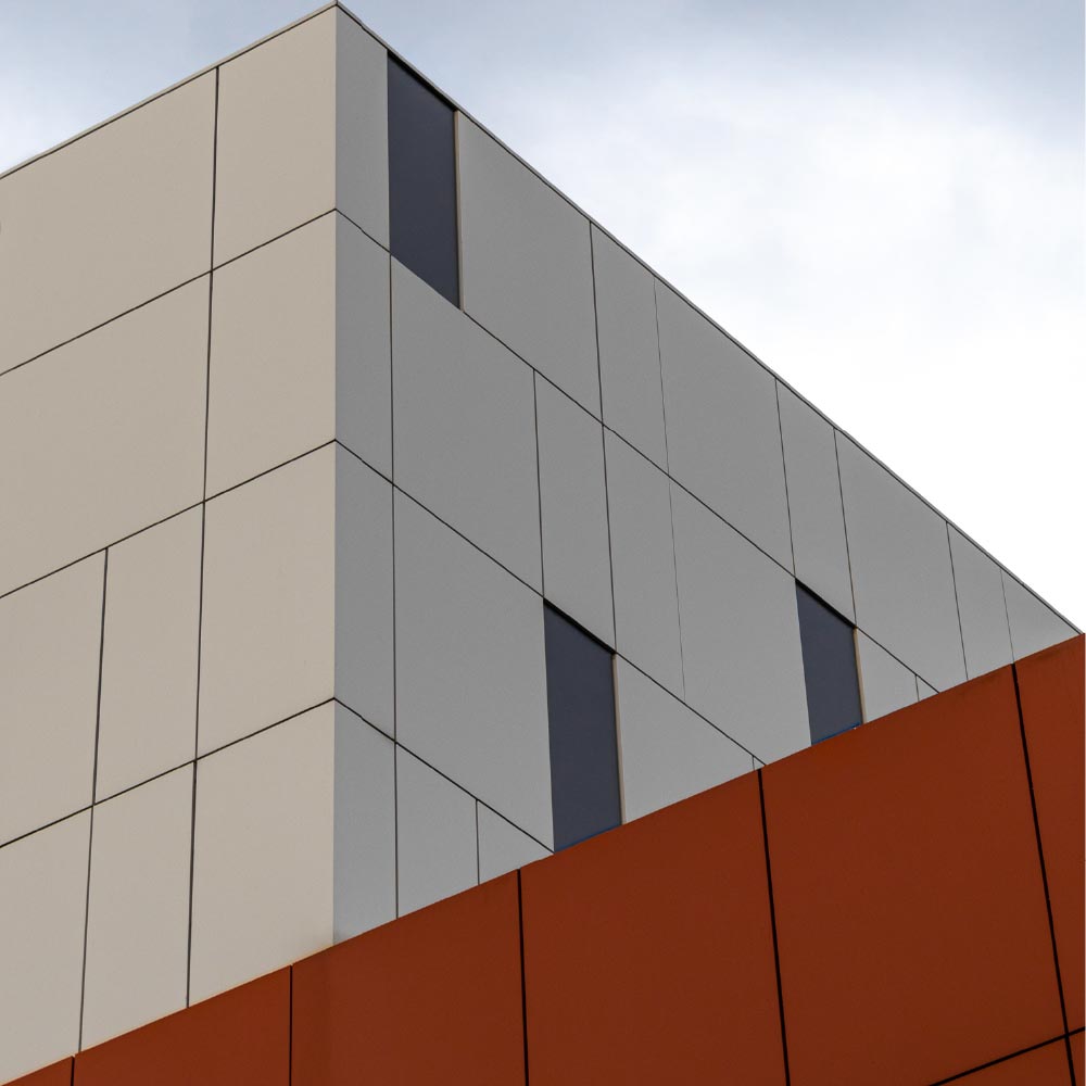 low angle view modern white orange building bright sky